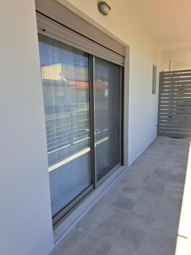 an empty room with sliding glass doors in a house at Giannis Apartment in Afantou