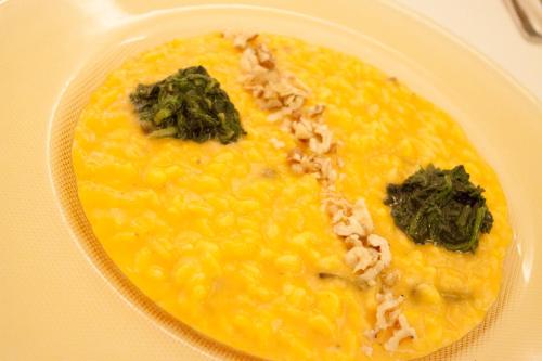 a plate of food with corn and greens on it at Park Hotel Italia in Tezze sul Brenta