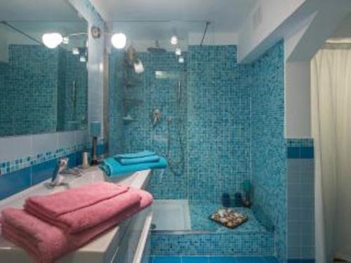 a bathroom with a tub and a shower with pink towels at L'appartamento di Monica in Casal Palocco
