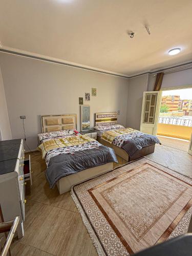 a bedroom with two beds and a window at ElShrouk United Agency in Bayāḑ al ‘Arab