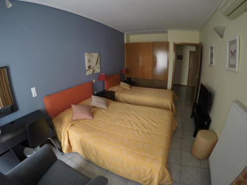 a bedroom with two beds in a room at Apartment Hotel Athina in Alexandroupoli