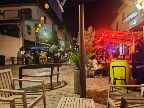 a group of people sitting at a restaurant at night at Boutique Hôtel de la Corniche d'Or in Mandelieu-la-Napoule