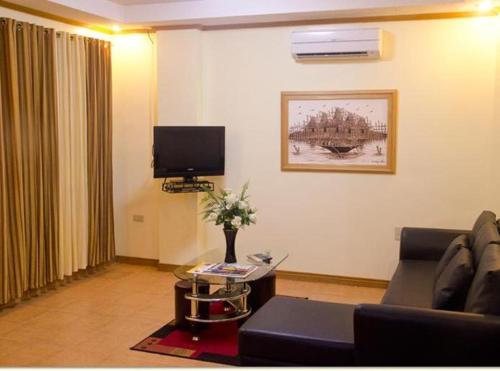 a living room with a couch and a tv at Casablanca Hotel Condominium Resort in Olongapo