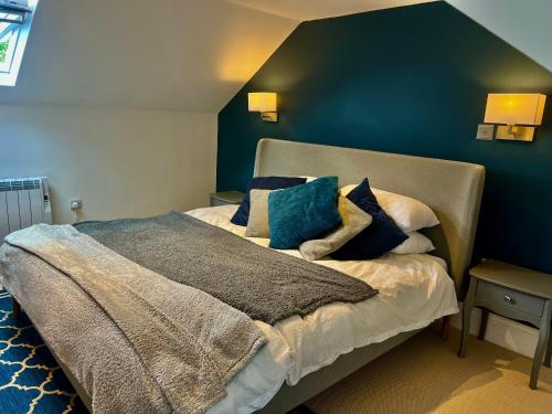 a bedroom with a large bed with blue walls at Central 3 bedroom apartment with superking and king beds in Bognor Regis