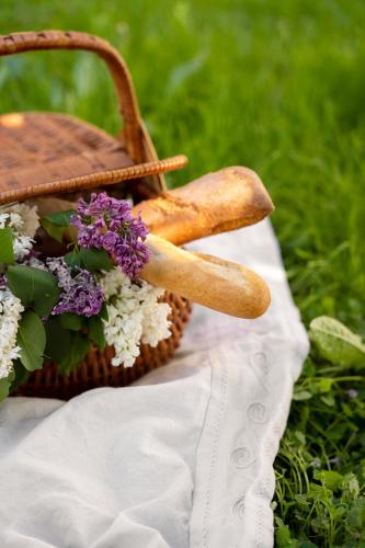a basket with a bunch of flowers and a stick at The Moment Luxury Suites in Parndorf