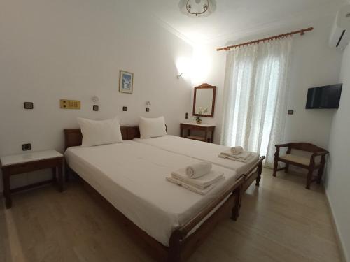 a bedroom with a bed with two towels on it at Hera 2 in Pythagoreio
