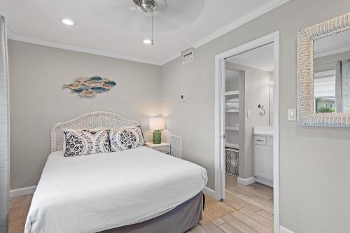 a bedroom with a white bed and a window at Capri by the Gulf 122 in Destin