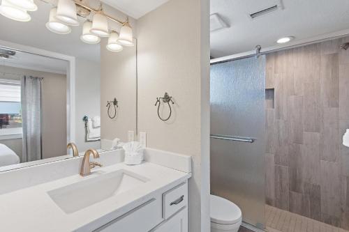 a white bathroom with a sink and a shower at Capri by the Gulf 122 in Destin