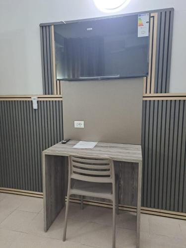 a desk with a chair in a room at Modena Hotel in Modena