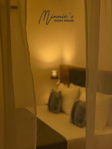 a window of a hotel room with a bed with pillows at Minnie's Guest House in Taytay