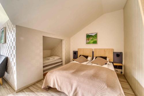 a bedroom with a large bed in a room at Sølvgarden Hotel in Rysstad