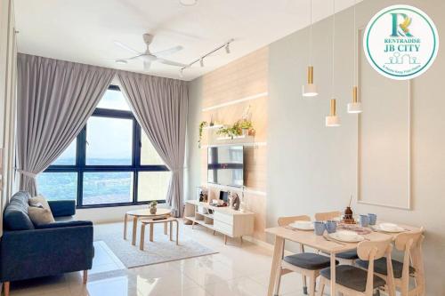 a living room with a blue couch and a table at Skudai Paradigm Mall by RR JBcity in Johor Bahru