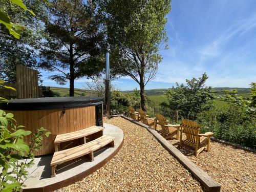 a wooden sauna with benches and trees at Whitebeam, Moor and Sea Holidays, beautiful views over Exmoor in Lynton