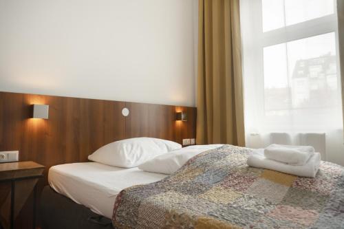 Postel nebo postele na pokoji v ubytování Hotel Klimt