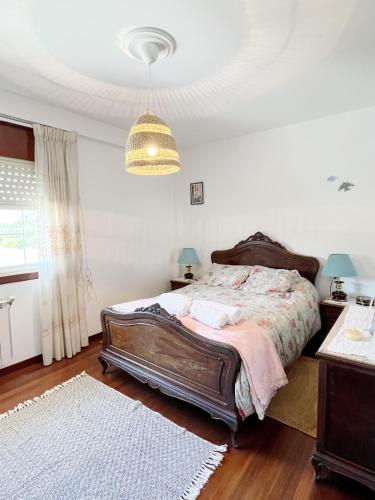 a bedroom with a bed and a chandelier at Casa María - 3km del Camino in Santa Eulalia
