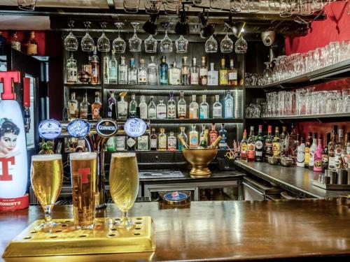 a bar with two glasses of champagne on a counter at The Tormaukin in Glendevon