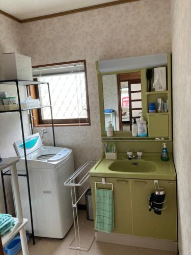 a bathroom with a sink and a washing machine at Monet House モネハウス in Shimo-horado