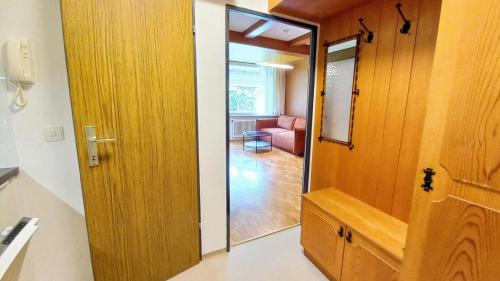 a door leading into a room with a living room at VERONIKA Haus KMB Seeappartement am Ossiacher See mit direktem Seezugang und Hallenbad in Tschöran