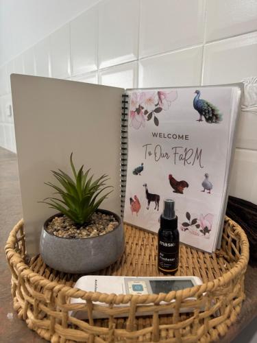 a basket with a book and a bottle of perfume at Farm Stay, Feed Sheep & Relax in Diggers Rest
