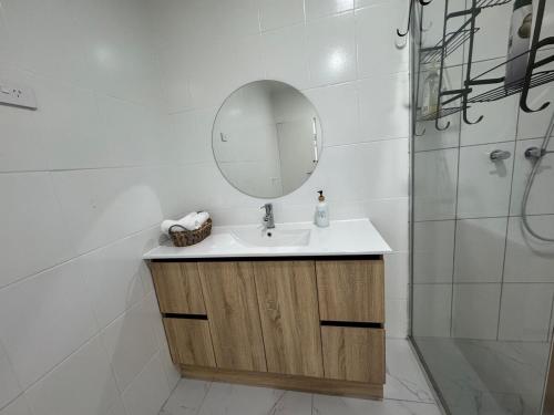 a bathroom with a sink and a mirror at Farm Stay, Feed Sheep & Relax in Diggers Rest