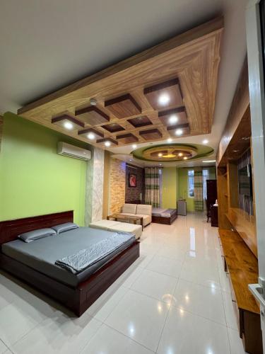 a bedroom with a bed and a living room at Hưng Thịnh 1 in Can Tho