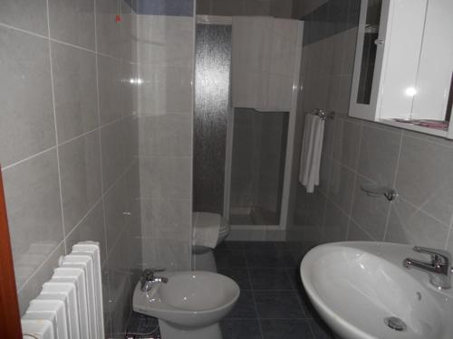 a bathroom with a white toilet and a sink at Hotel Polo in San Felice sul Panaro