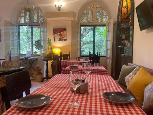 a dining room with a table with a red and white table cloth at Casa Do Leão A 150 year Old Portuguese Home in Nerul