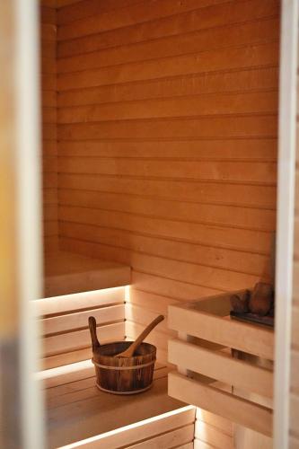 a wooden sauna with a wooden bucket in it at Vilas & Wellness Resort Orlík in KozÃ¡rovice