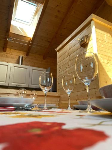 four wine glasses sitting on a table in a kitchen at Bella Italia chalet in Massino Visconti