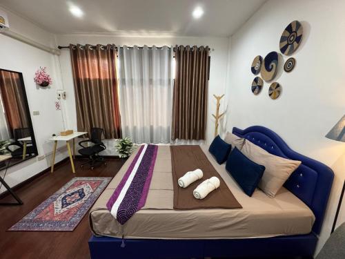 a bedroom with a blue bed in a room at Twenty One Place in Bangkok