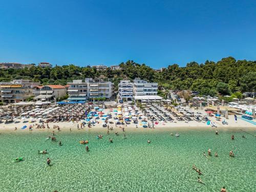 a group of people in the water at a beach at Poseidon Edge by RentalsPro - Kallithea Halkidiki in Kallithea Halkidikis