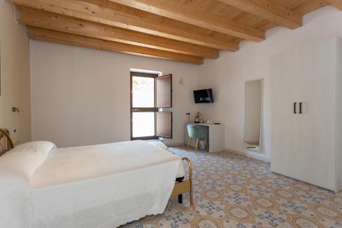 a bedroom with a bed and a desk in a room at Villa De Santis in Praia a Mare