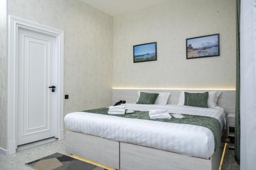 a bedroom with a large white bed in a room at Marmaris Saray hotel NEW in Tashkent