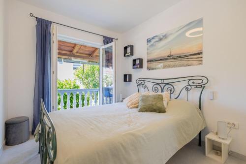 a bedroom with a bed and a balcony at Apartmani Simona Tribunj in Tribunj