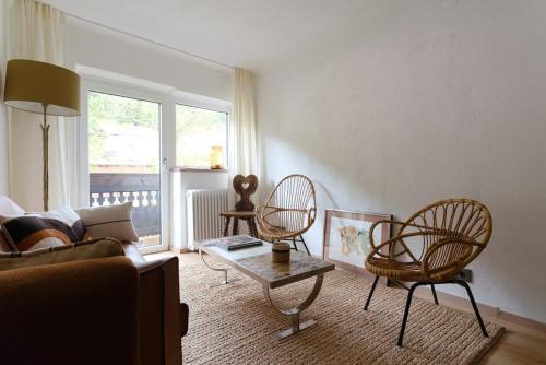 a living room with a couch and two chairs and a table at Cosy & Style Zell am See in Schmitten