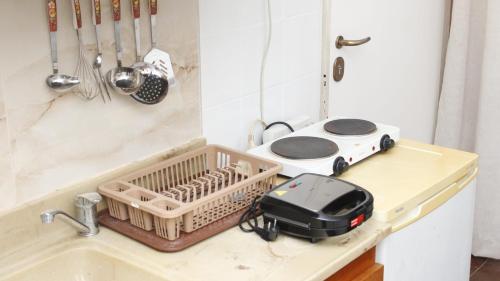 a kitchen counter with a sink with a toaster at Studio to rent in front of the amazing sea in Nea Plagia