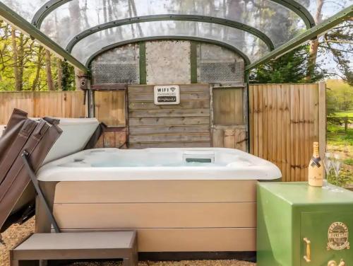 a jacuzzi tub in a greenhouse at The Train Carriage in NWI