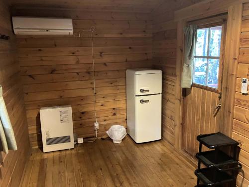 an empty room with a refrigerator and a fan at PICA Fujiyoshida in Fujiyoshida