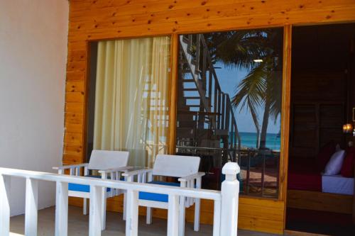 a dining room with a view of the ocean at Golden Beach Cottages in Trincomalee