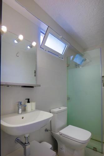 a bathroom with a sink and a toilet and a window at VILLA avec Rooftop Bahia Smir bord de mer in Fnidek