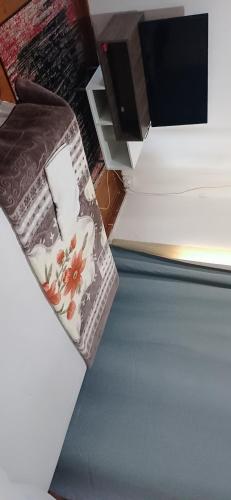 a bed with a pillow with flowers on it at Cheap accommodation short term stays in Pietermaritzburg