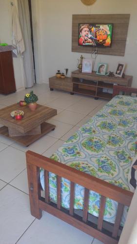 a bedroom with a bed and a tv and tables at Golden Dunas 123B in Extremóz