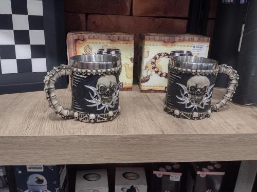 two mugs with skulls on them sitting on a shelf at Golden Dunas 123B in Extremóz