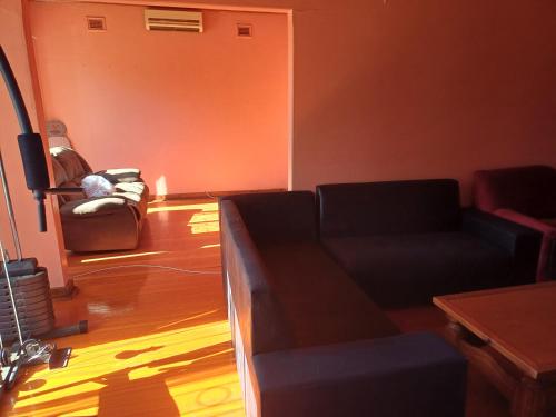 a living room with a couch and a table at Cheap accommodation short term stays in Pietermaritzburg