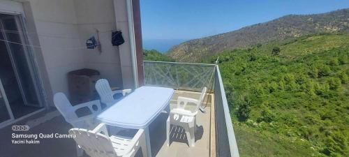 d'un balcon avec une table et des chaises. dans l'établissement BEJAIA Location Appartements de 49 à 59eur, à Béjaïa