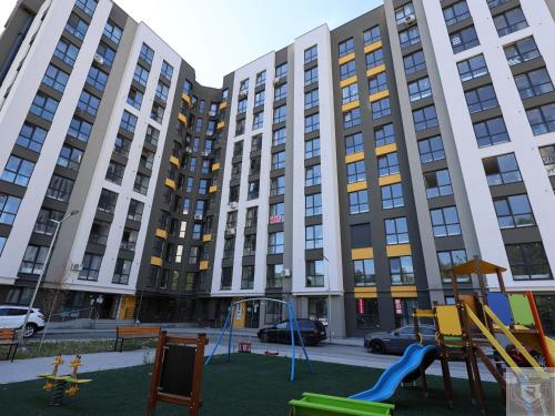 an empty playground in front of a large building at RentHouse Apartments - Airport Loft in Chişinău