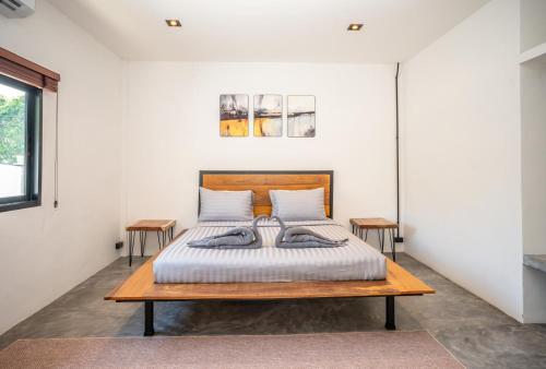 a bedroom with a bed and two tables at Aqua Suites in Wok Tum
