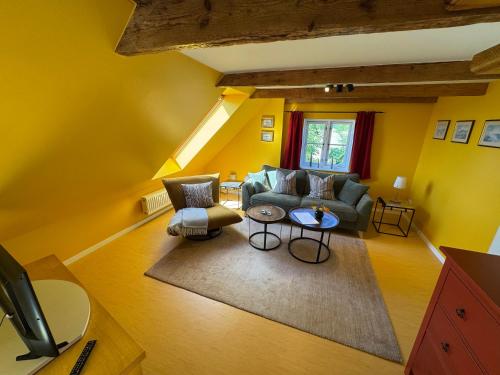 a living room with a couch and a table at Vogelhaus Gobbin in Lancken-Granitz
