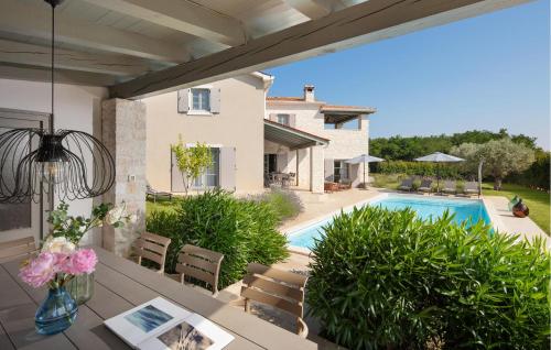 a patio with a table and a swimming pool at Villa Corinne in Štuti