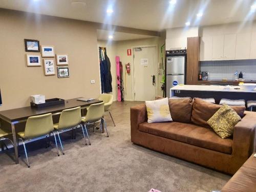 a living room with a couch and a table at Absollut 09 in Mount Hotham